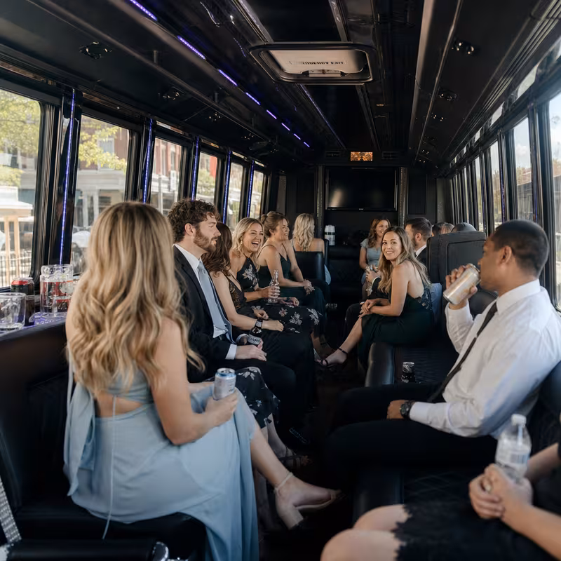 Wedding guests seated inside a Rochester party bus