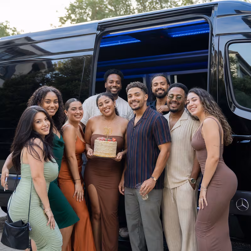 Group boarding a white charter bus for Birthday Transportation transportation in Rochester