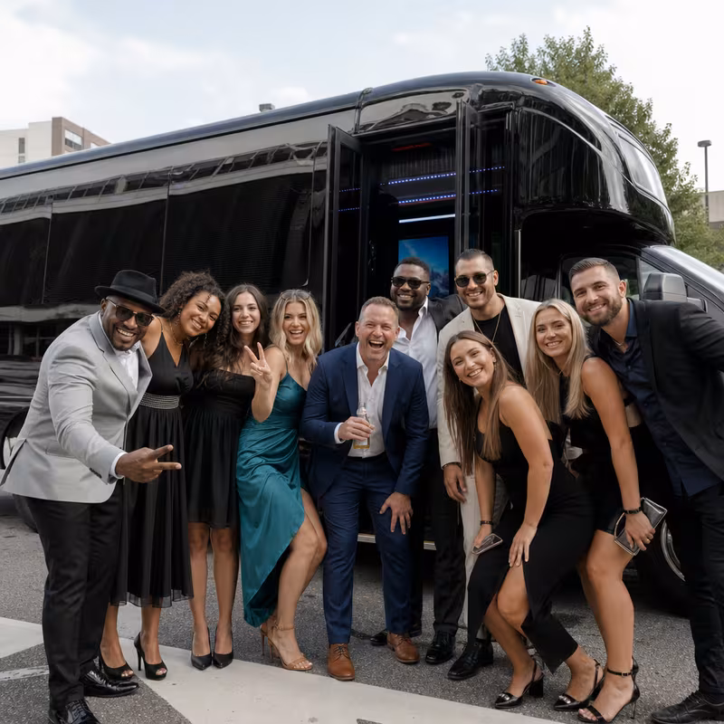 Party bus interior with wraparound leather seating and LED lighting in Rochester