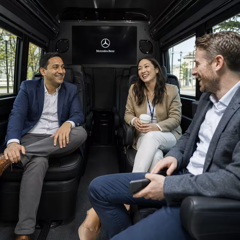 Group boarding a white charter bus for Corporate Transportation transportation in Rochester