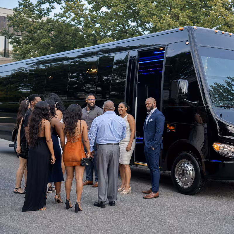 Passengers loading luggage while boarding an Rochester group shuttle