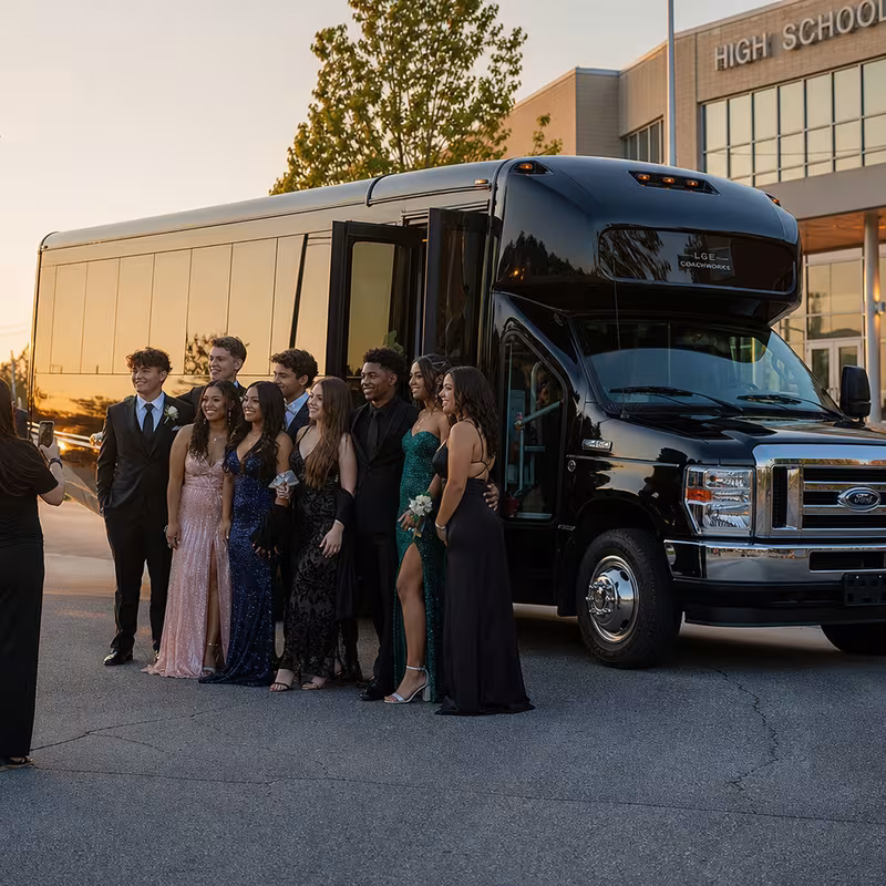 Group boarding a white charter bus for Prom & Homecoming Transportation transportation in Rochester