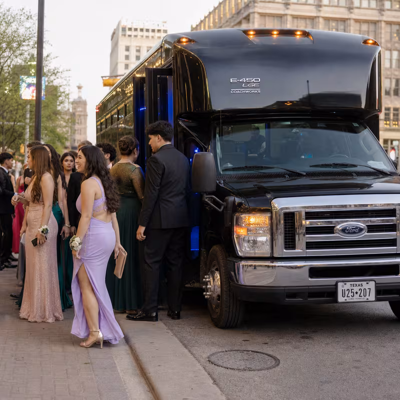 Passengers loading luggage while boarding an Rochester group shuttle