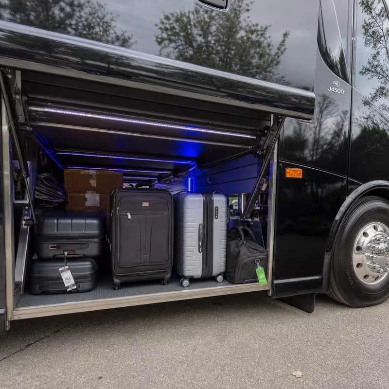 Party bus interior with wraparound leather seating and LED lighting in Rochester