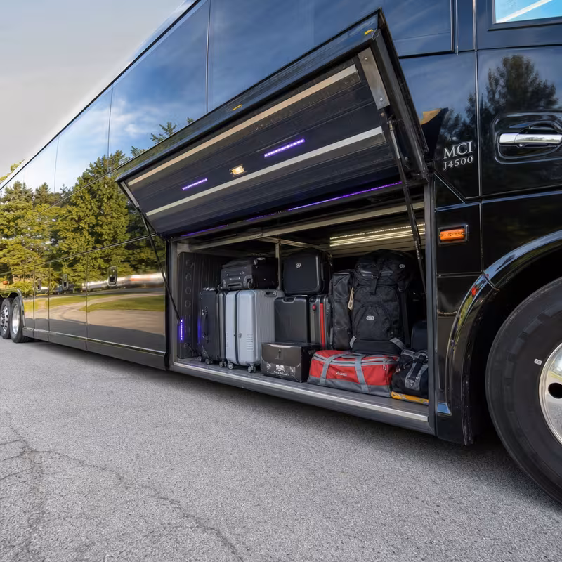 Party bus interior with wraparound leather seating and LED lighting in Rochester