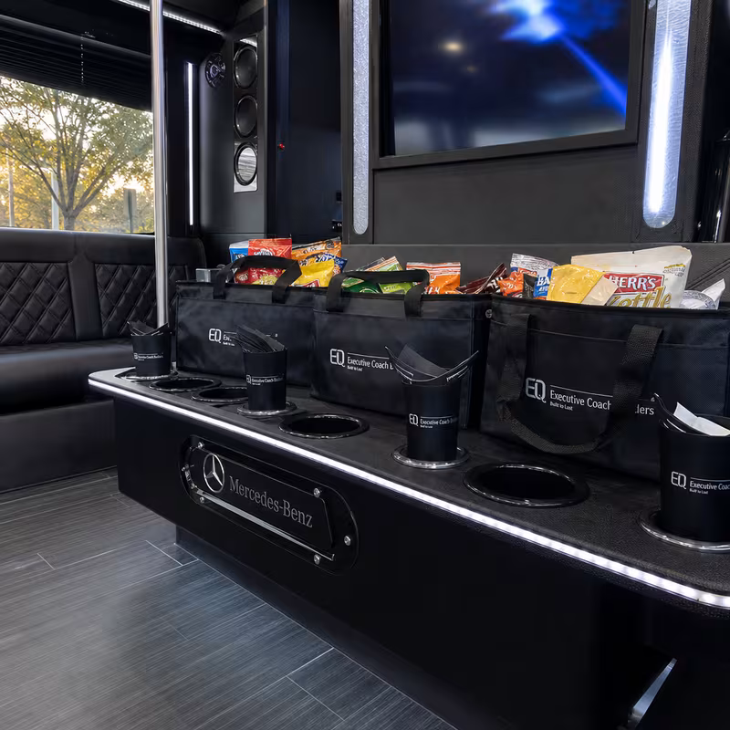 Party bus interior with wraparound leather seating and LED lighting in Rochester