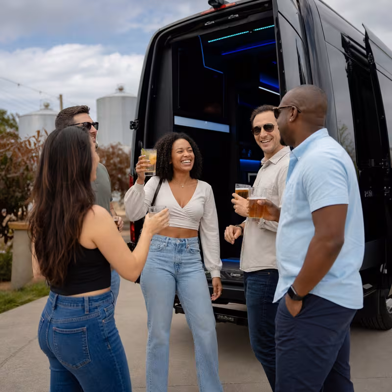 Passengers loading luggage while boarding an Rochester group shuttle
